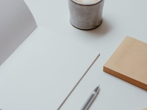 A simple, organized desk with a plant, showing a calm daily routine.