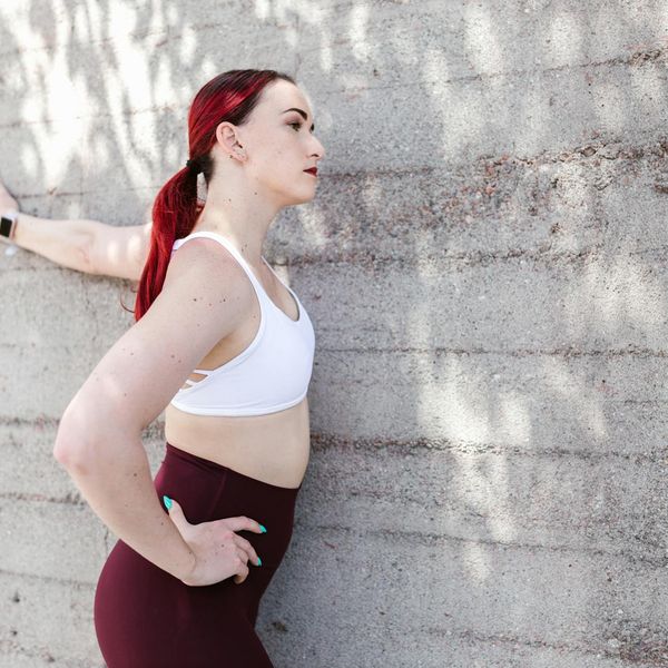 Person stretching outdoors at sunrise, feeling energized and refreshed.